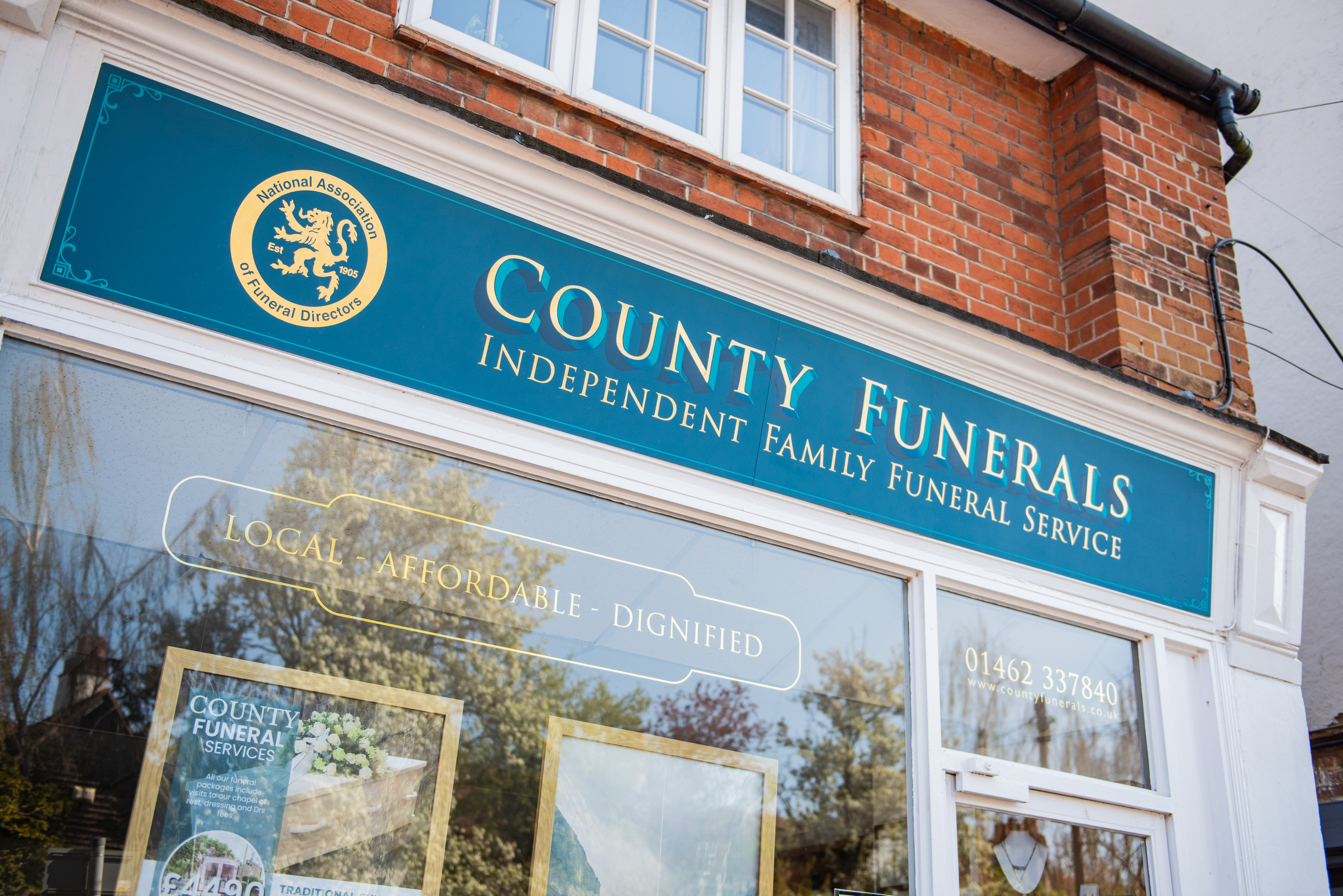 Close up of the County Funerals office signage and window